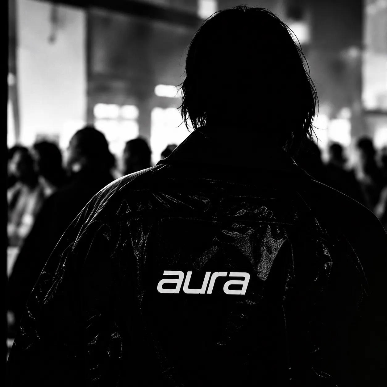 Person in an Aura hoodie, seen from behind